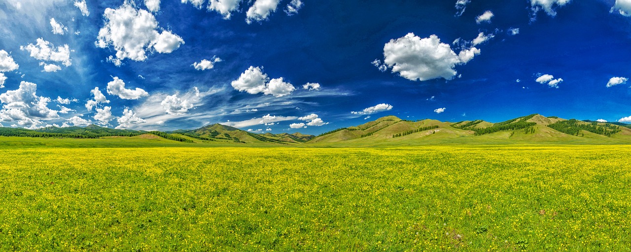 green and blue landscape with clouds